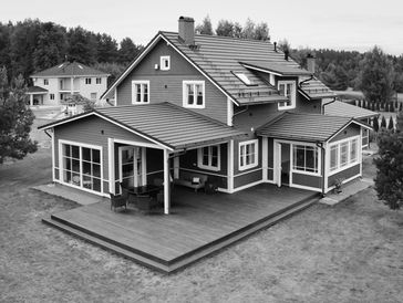 Black and white image of a large, modern two-story house