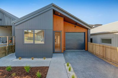 Modern single-story house with gray and wood exterior.