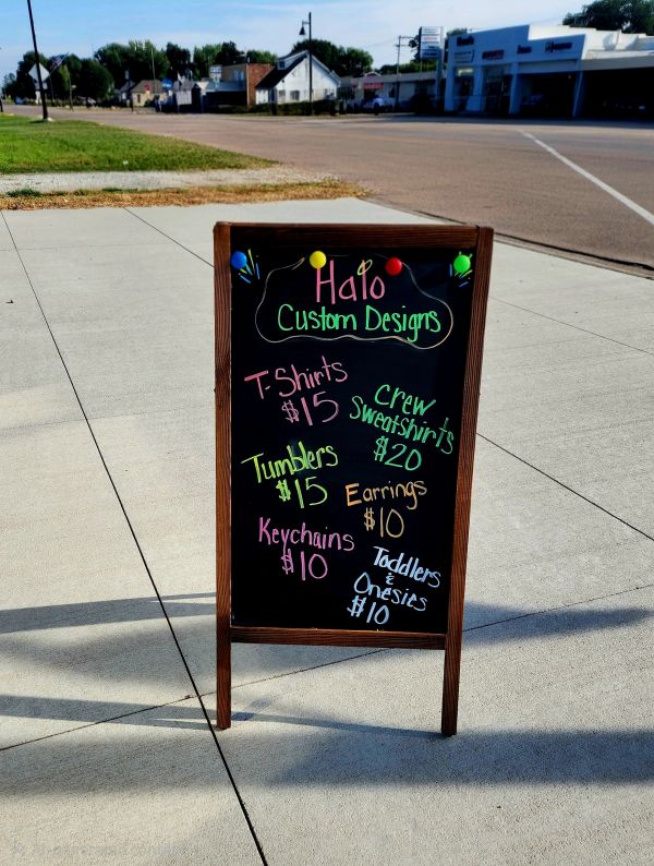 Outdoor sandwich board advertising custom designs and apparel.
