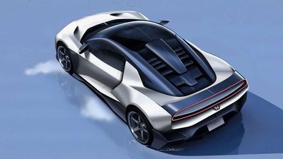 Sleek white sports car with black accents seen from above.