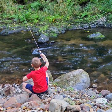 Young child fishing in a stream