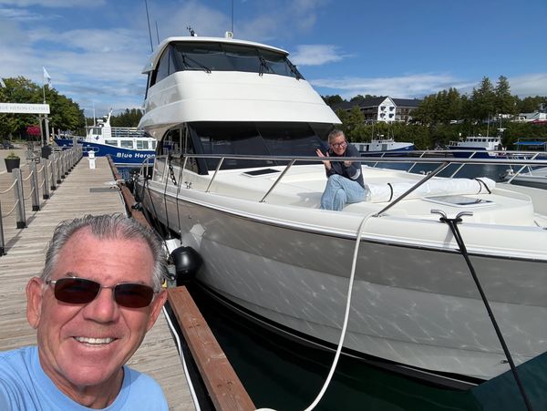 Two people enjoying time on a yacht at the dock.