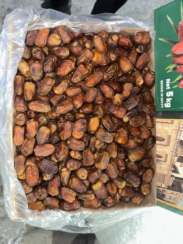 Box filled with dried dates, ready for sale or consumption.