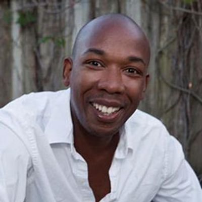 Smiling man in a white shirt.