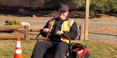 Person riding a Gravely lawn mower.