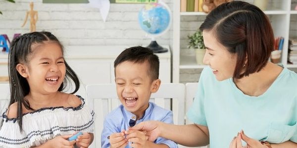 Children and woman laughing and having fun.