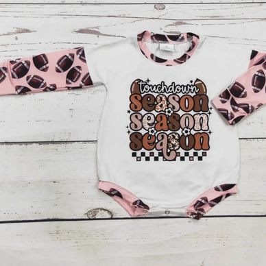 Baby onesie with football-themed design and 'touchdown season' text.