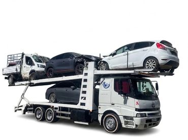 Car transporter truck loaded with three cars on white background.