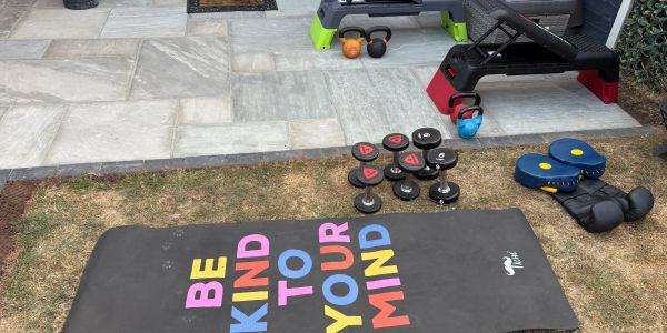 Outdoor workout setup with weights and equipment.