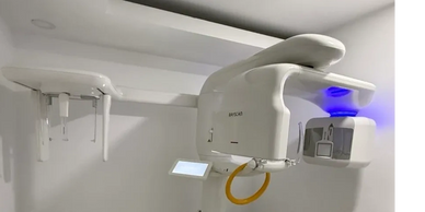 Modern dental X-ray machine with blue light in a clean room.