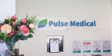 Reception area of Pulse Medical with a floral arrangement.