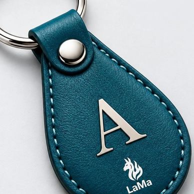 Teal leather keychain with silver letter A and LaMa logo.