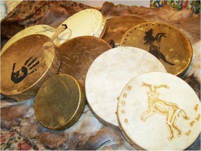 A collection of traditional hand drums with painted designs.