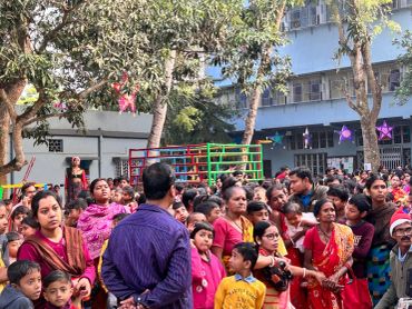 Crowd gathered outside a building during daytime.