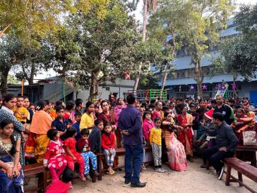 Group of people gathered outdoors in colorful attire.