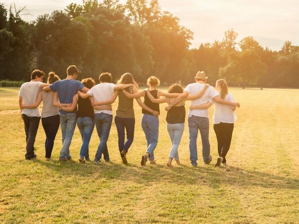 A team of doulas and medical professionals linking arms.