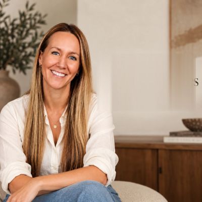 Smiling woman with long hair in casual outfit.
