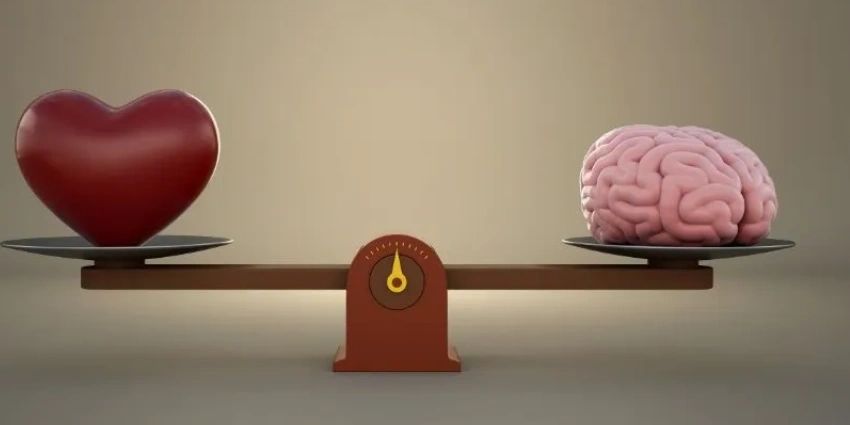 A heart and brain balanced equally on a scale.