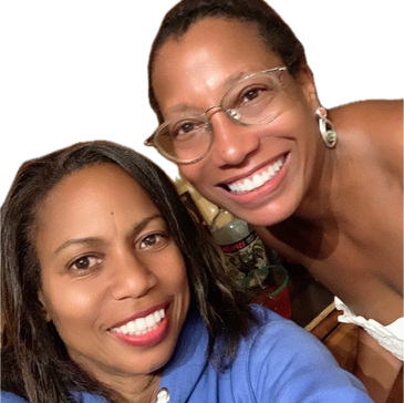 Two smiling women posing closely for a selfie indoors.