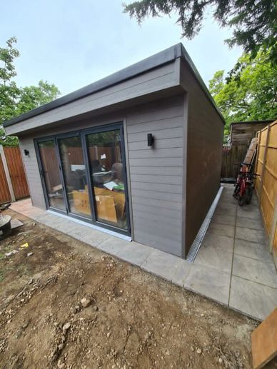 Modern insulated garden outbuilding with sliding doors completed in Hounslow, West London.