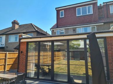 Rear house extension with aluminium heritage doors and rooflights completed in Hounslow, West London