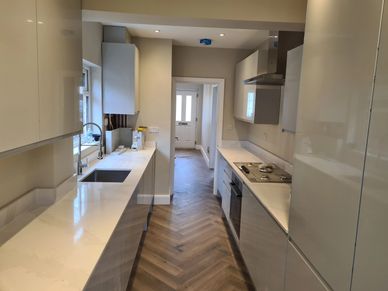 Modern kitchen renovation with quartz worktops and herringbone flooring completed in Hounslow, West 