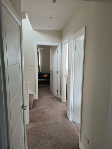 Renovated first floor landing with new carpet, modern doors and fitted storage in Hounslow, West Lon
