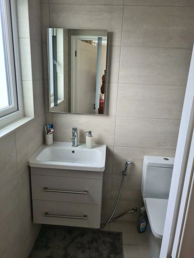Modern loft en-suite bathroom with walk-in shower, vanity unit and large-format tiles in Hounslow, W