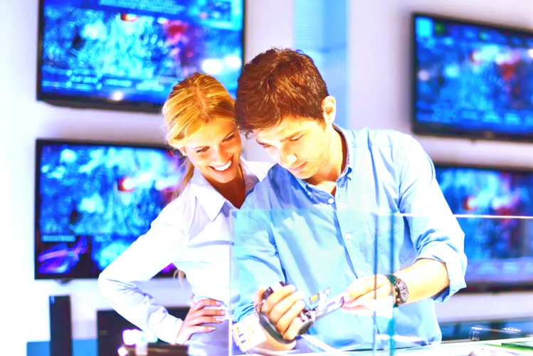 a girl and a guy looking at technology and smiling