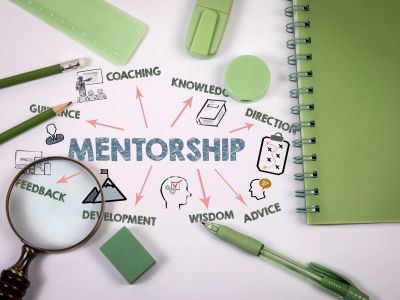 Mentorship concept with stationery and keywords.