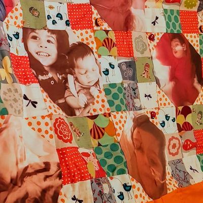 Memorial quilt with pictures of a baby 