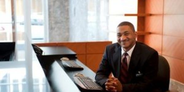 Concierge Security Guard stationed at the front desk of a hotel