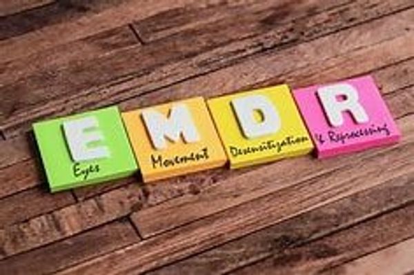 Colorful blocks spelling EMDR with words related to therapy.