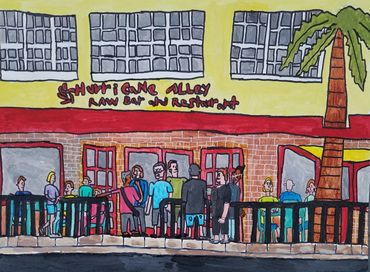 "Hurricane Alley " restaurant in Boynton Beach, Florida with a palm tree  and people eating on outsi