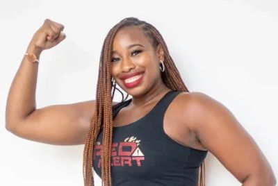 Smiling woman flexing her arm muscle.