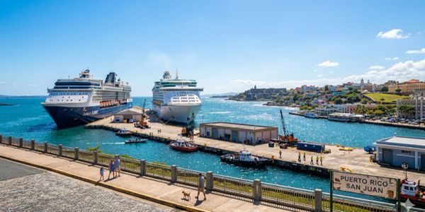 Two cruise ships docked at San Juan port in Puerto Rico on a sunny day.
