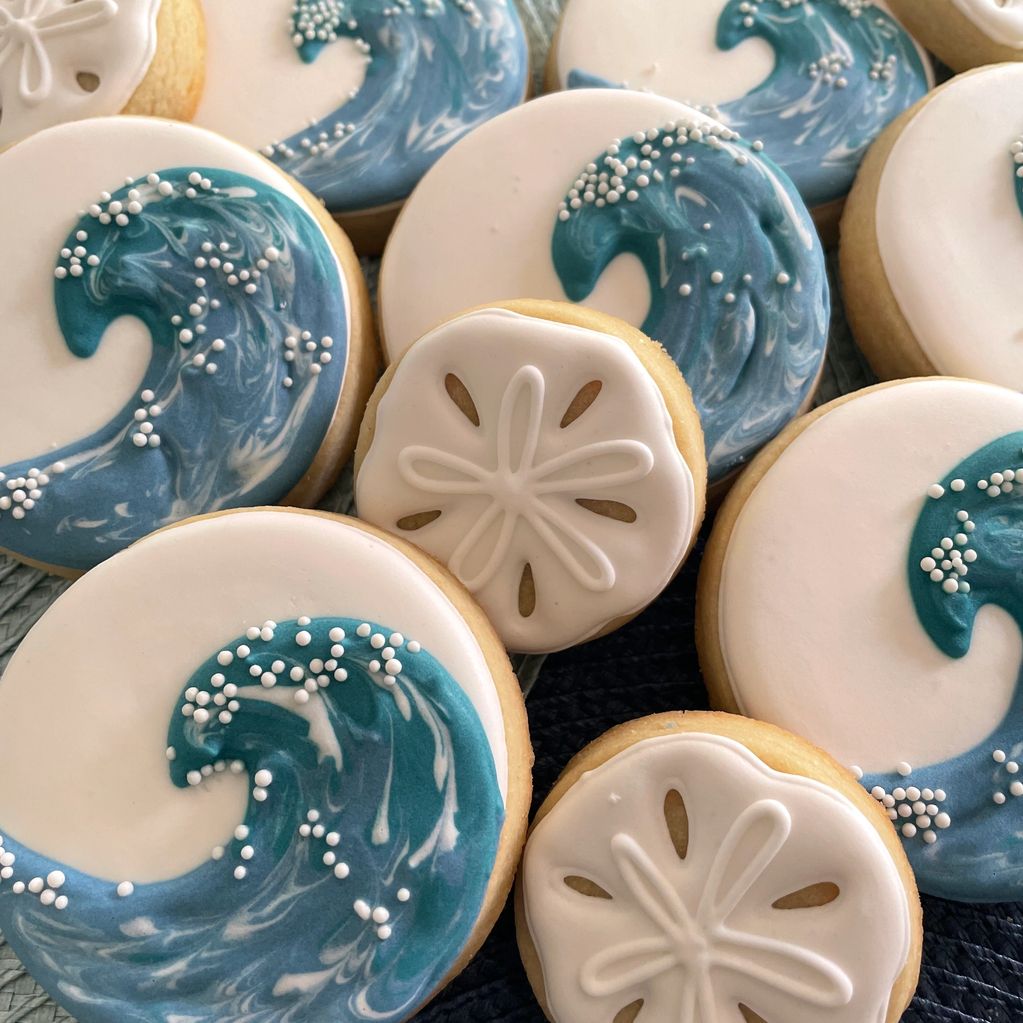 Ocean wave and sand dollar decorated cookies.