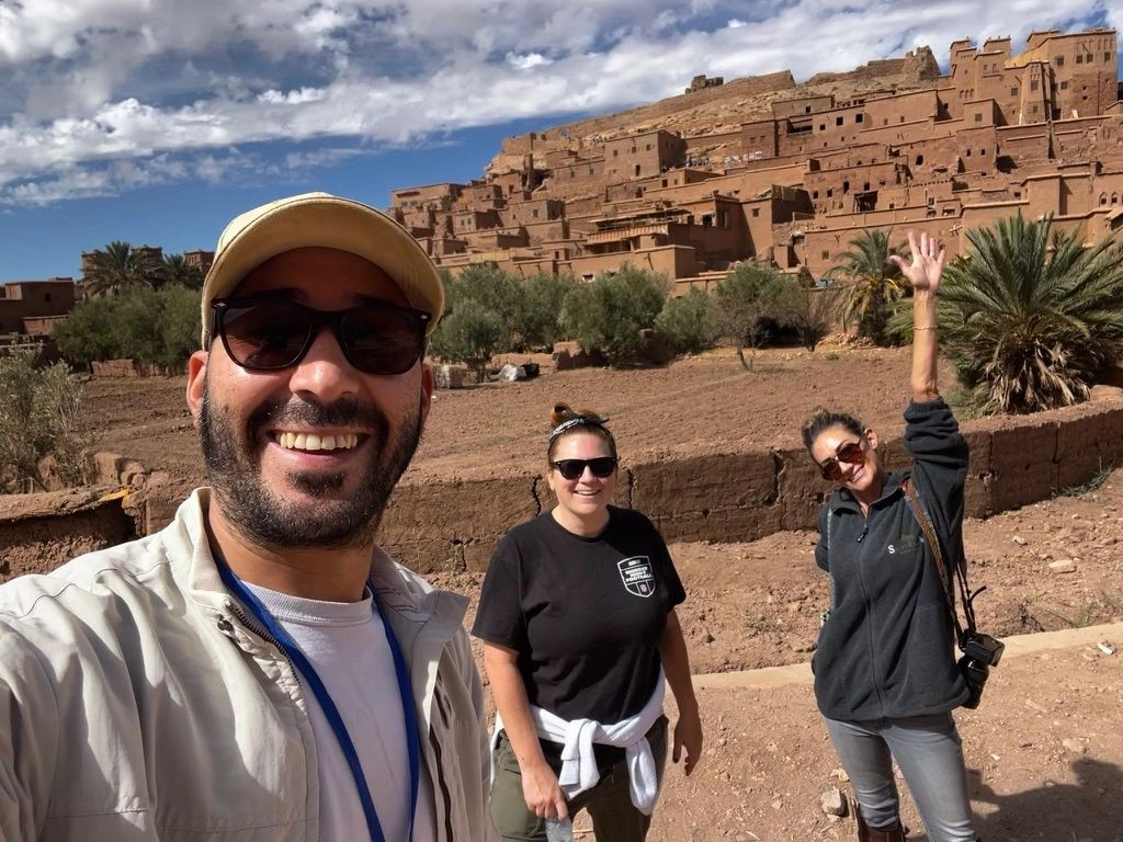 Moroccan tour guide with American tourists at Aït Benhaddou, a UNESCO World Heritage Site