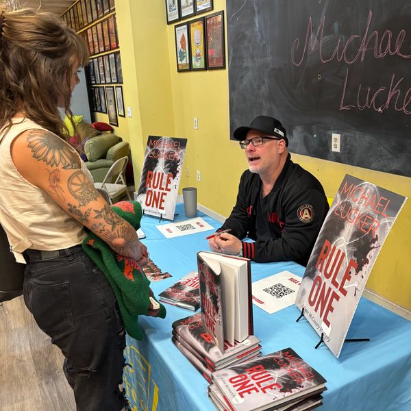 Author Michael Lucke signing books at an event.