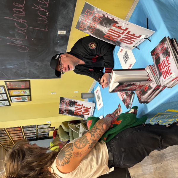 Author Michael Lucke signing books at an event.