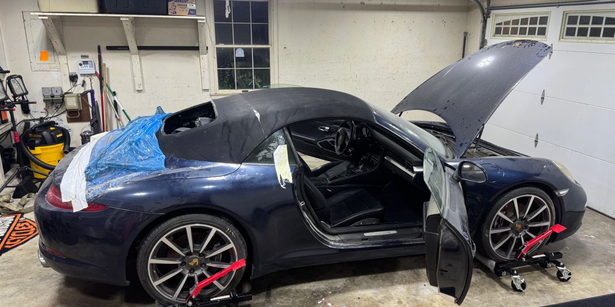 The blue Project 911 Carrera Cabriolet in the workshop during its fire-damage rebuild.