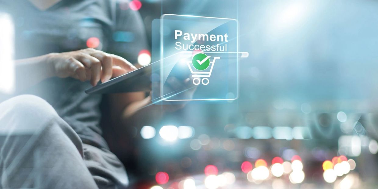 Person using a tablet with a 'Payment Successful' notification overlay.