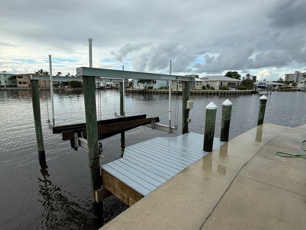 Boat dock lift by waterfront.