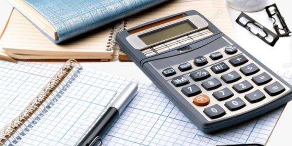 Calculator, pen, and notebooks arranged on a desk for work.