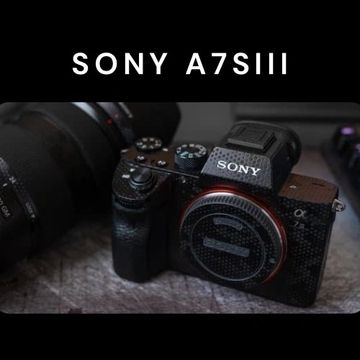 Close-up of a Sony A7SIII camera on a textured surface.