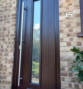 Rosewood solid core composite door with matching Rosewood Frame. Modern contemporary long bar handle