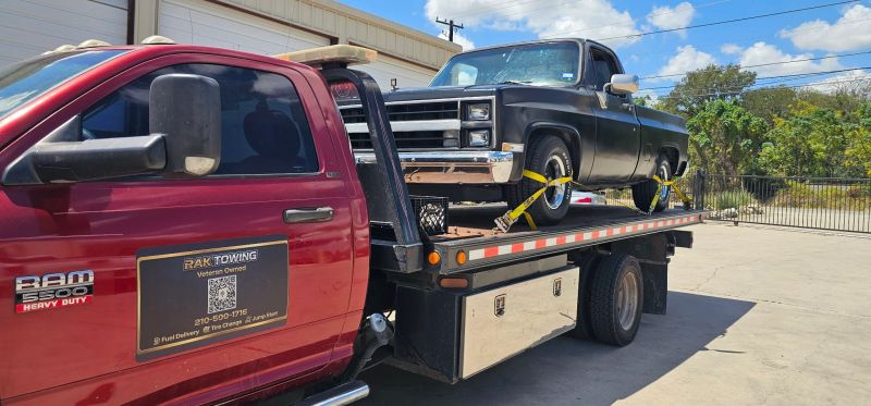 RAK Towing flatbed carrying a classic truck