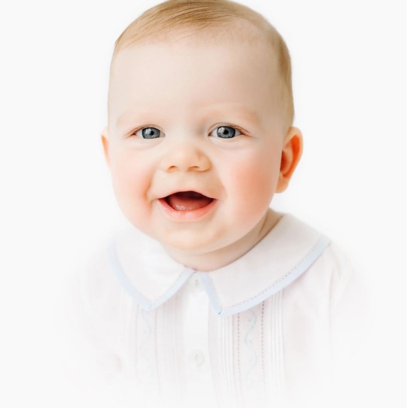 heirloom portrait of one year old boy smiling