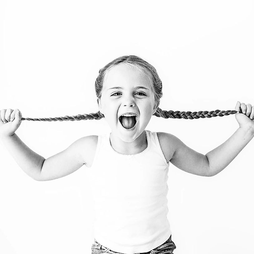girl pulling her braids and yelling black and white 