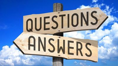 Wooden signs point to 'Questions' and 'Answers' against a blue sky.